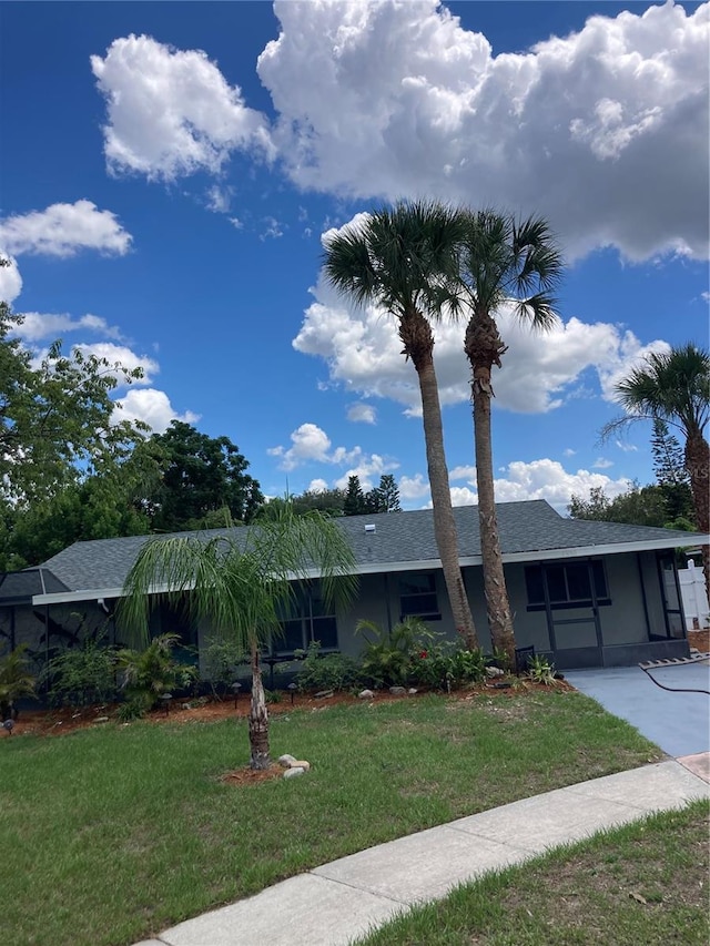 view of front of property with a front yard and a carport