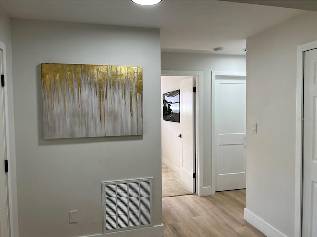 hall with light hardwood / wood-style flooring