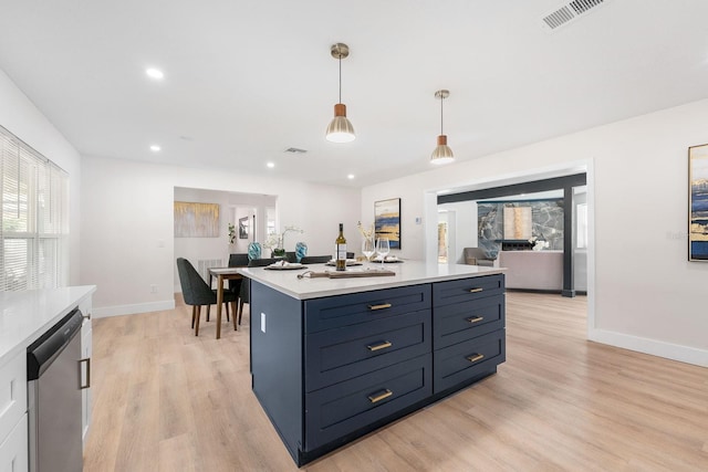 kitchen with dishwasher, hanging light fixtures, light hardwood / wood-style flooring, blue cabinets, and a kitchen island