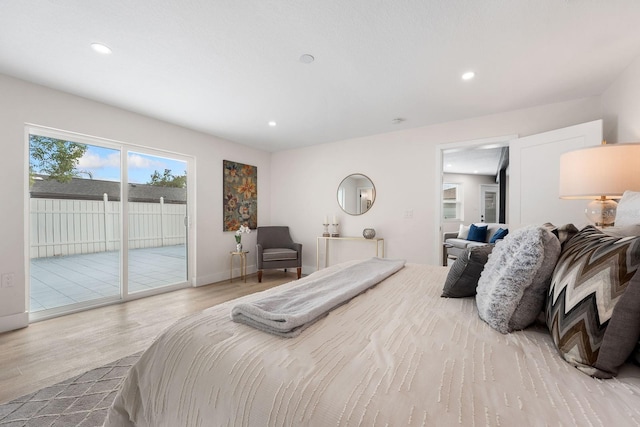 bedroom with light hardwood / wood-style floors and access to outside