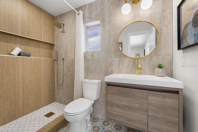 bathroom with walk in shower, vanity, toilet, and tile walls