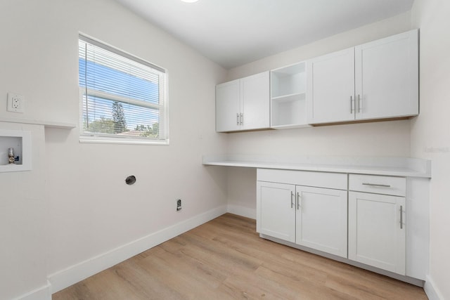 laundry area featuring light hardwood / wood-style floors, cabinets, and hookup for a washing machine