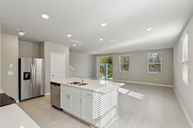 kitchen with white cabinetry, sink, an island with sink, and stainless steel appliances