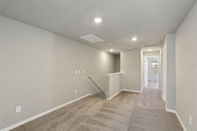 hallway featuring light carpet