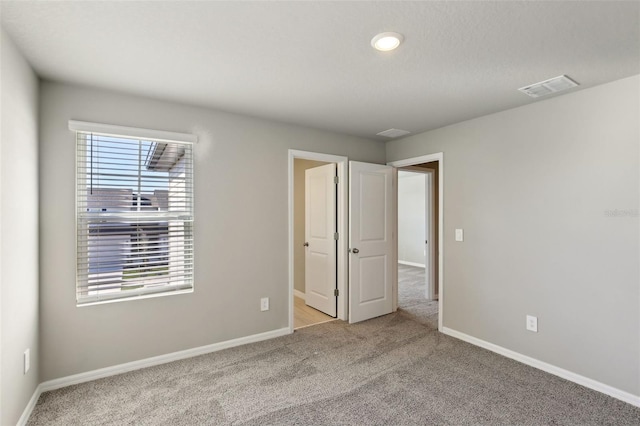 unfurnished bedroom with light carpet