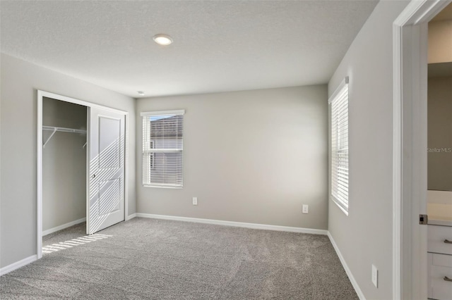 unfurnished bedroom with carpet, multiple windows, and a closet