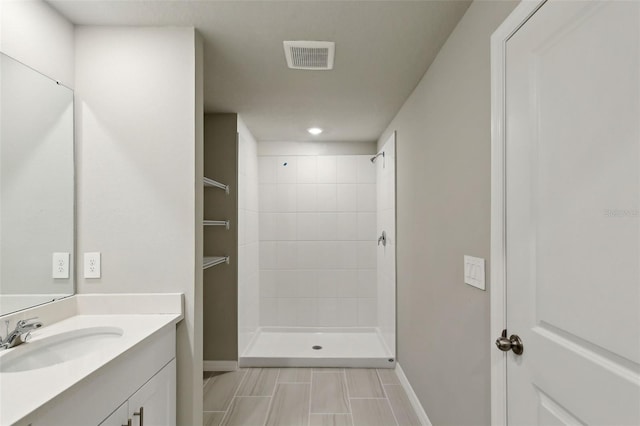 bathroom featuring vanity and a tile shower