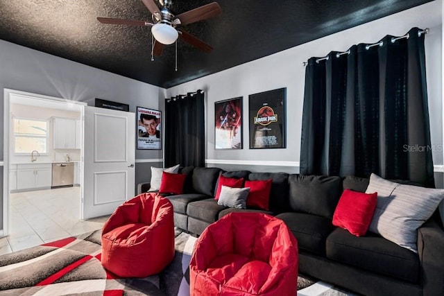 tiled living room with ceiling fan and a textured ceiling