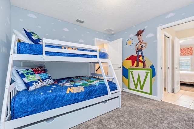 carpeted bedroom featuring a textured ceiling