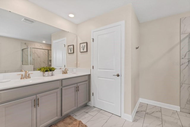 bathroom with vanity and a shower with door