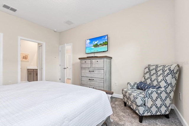 carpeted bedroom featuring ensuite bathroom