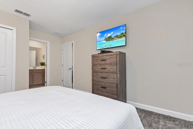 carpeted bedroom featuring connected bathroom