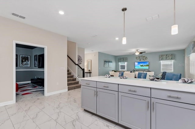 kitchen with gray cabinets, hanging light fixtures, and ceiling fan