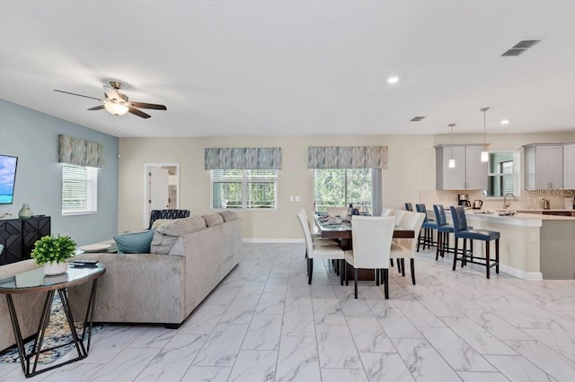 dining area with ceiling fan and a healthy amount of sunlight