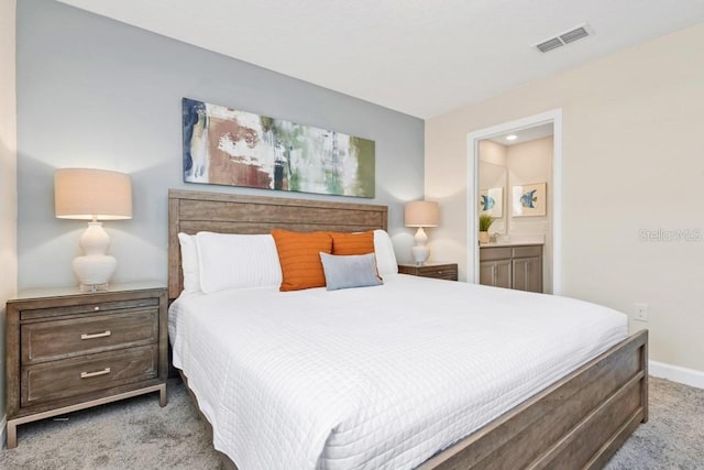 carpeted bedroom with ensuite bathroom