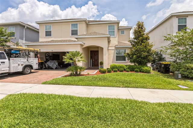 mediterranean / spanish-style house with a garage and a front yard