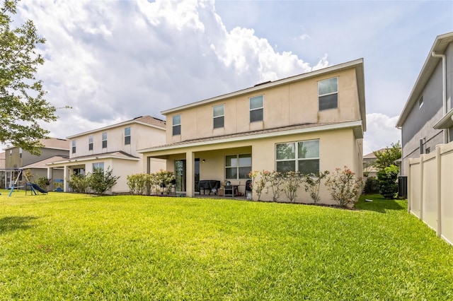 rear view of property featuring a patio, a yard, and central AC unit