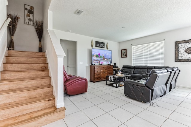 living room featuring light tile flooring and a textured ceiling