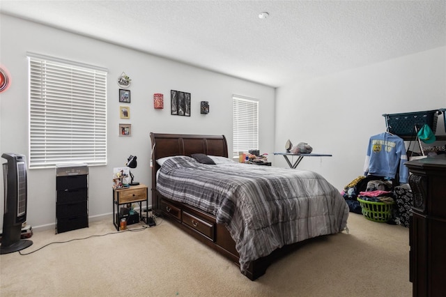 carpeted bedroom featuring a textured ceiling