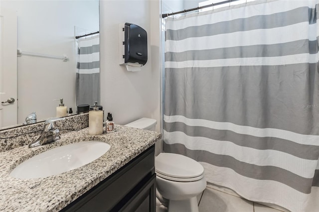 bathroom featuring tile flooring, oversized vanity, and toilet