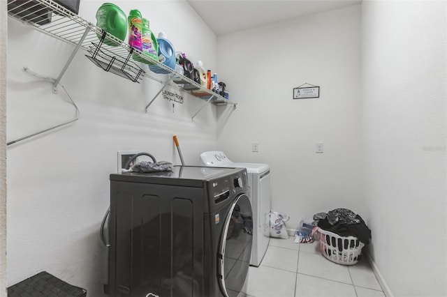 laundry area with washer and dryer, light tile floors, and hookup for a washing machine