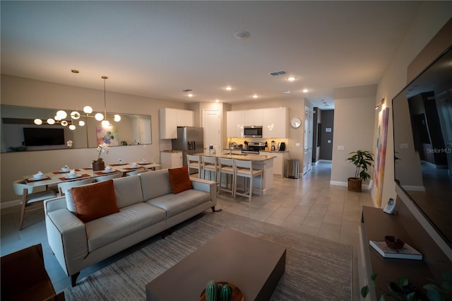 living room with light tile patterned flooring and sink