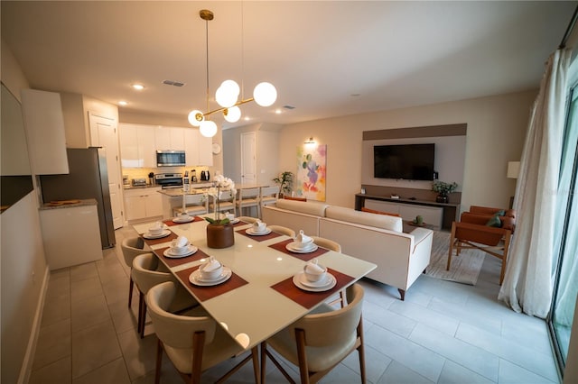 dining room featuring a notable chandelier and light tile patterned floors