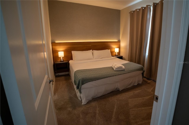 carpeted bedroom featuring wooden walls