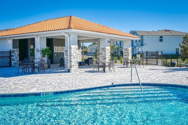 view of swimming pool featuring a patio area