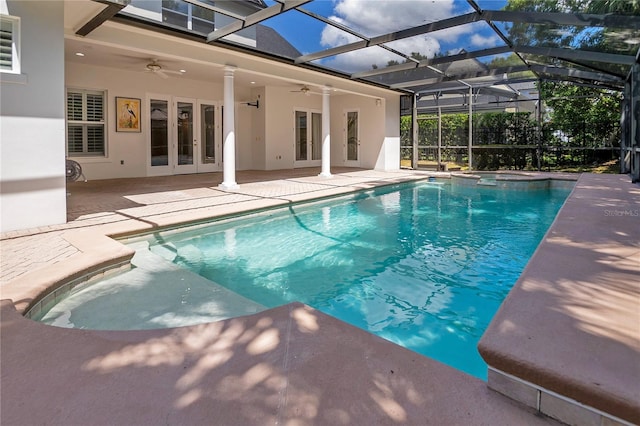 view of swimming pool featuring french doors, a lanai, ceiling fan, and a patio area