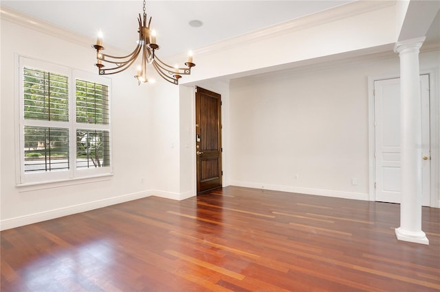 unfurnished room with dark hardwood / wood-style flooring, crown molding, and a notable chandelier