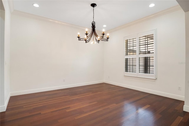 empty room featuring ornamental molding, an inviting chandelier, and dark wood-type flooring