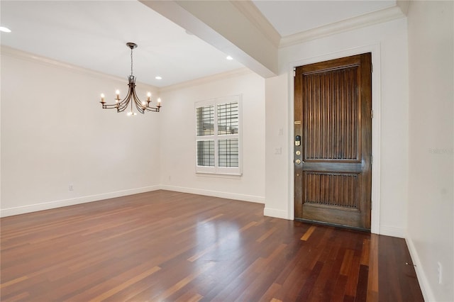 unfurnished room with dark wood-type flooring, crown molding, and an inviting chandelier