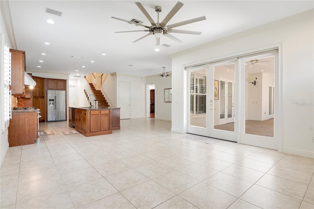 unfurnished living room featuring french doors, ceiling fan, sink, and light tile flooring