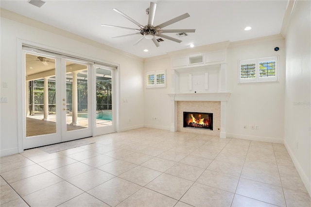 unfurnished living room featuring ornamental molding, french doors, ceiling fan, and light tile floors