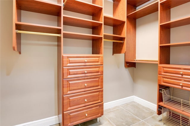 walk in closet featuring light tile flooring