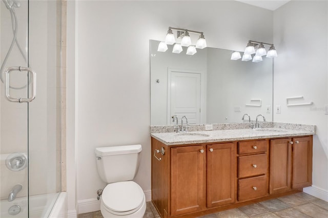 bathroom featuring tile floors, toilet, and double sink vanity