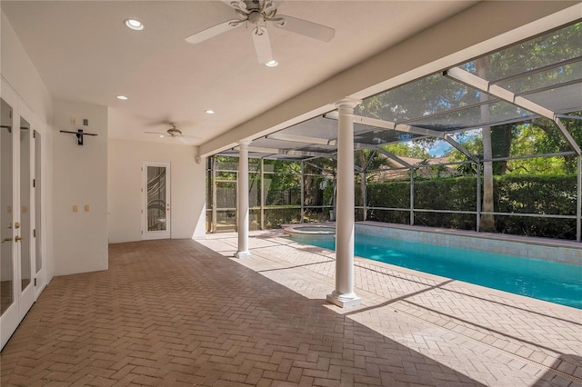 view of swimming pool featuring a lanai, ceiling fan, and a patio area