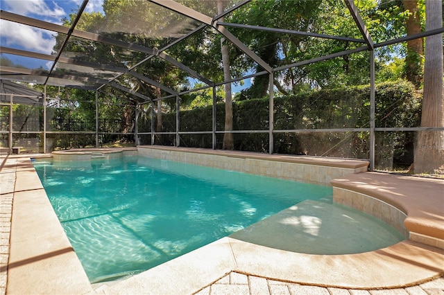 view of pool with glass enclosure