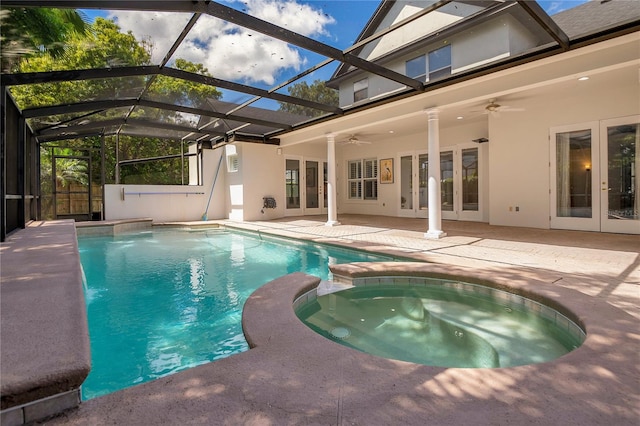 view of pool with a patio area, ceiling fan, an in ground hot tub, glass enclosure, and french doors