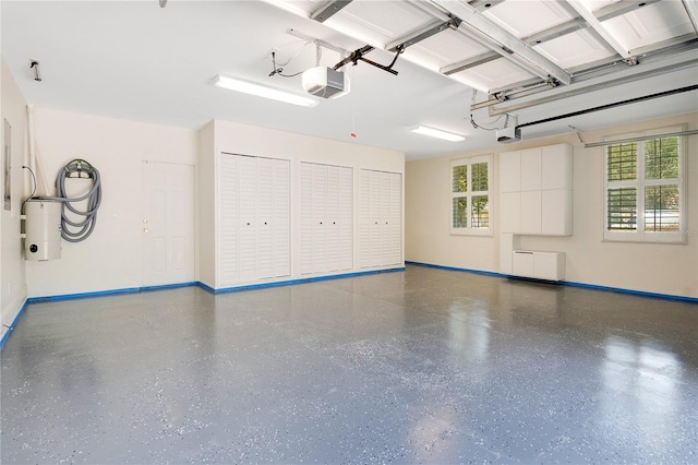 garage featuring water heater and a garage door opener