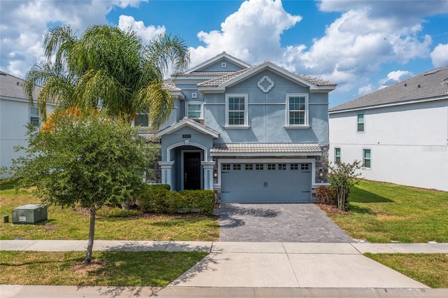 view of front of home featuring a garage and a front yard