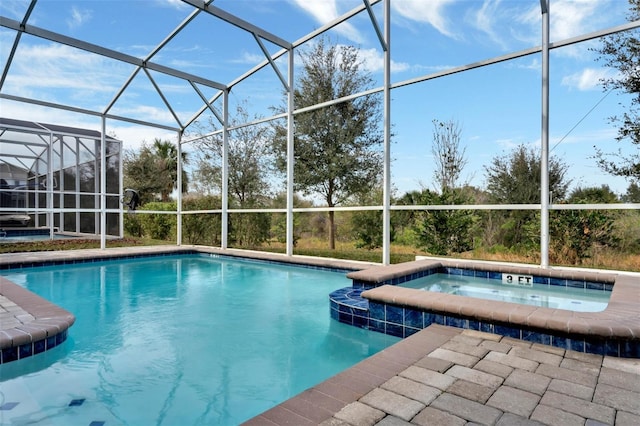 view of pool featuring an in ground hot tub and a lanai