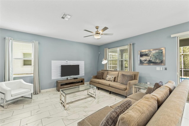 living room with plenty of natural light and ceiling fan