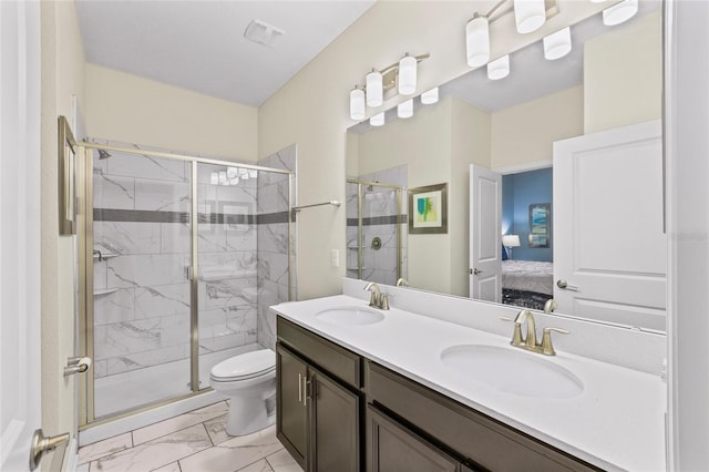 bathroom with vanity, an enclosed shower, and toilet