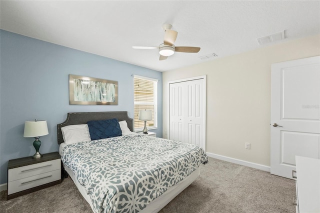 carpeted bedroom with a closet and ceiling fan