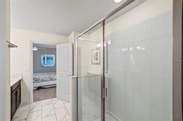 bathroom with vanity, a textured ceiling, and walk in shower