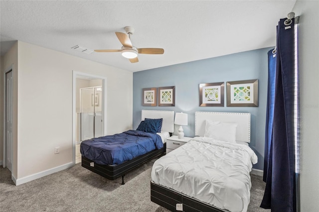 carpeted bedroom with ceiling fan, connected bathroom, and a textured ceiling