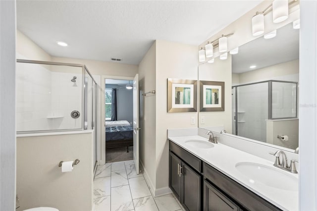 bathroom with walk in shower, vanity, and a textured ceiling