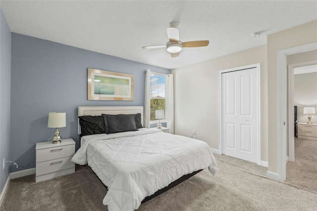 bedroom featuring ceiling fan, a closet, and carpet